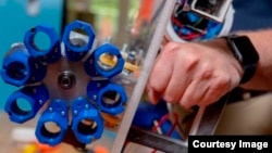 A close-up of the carousel that moves the spear tips into position to be driven into lionfish. One of the robot’s cameras can be seen in the small watertight box at left. (Worcester Polytechnic Institute)