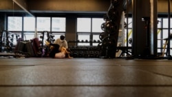 Gym member exercises at a fitness club in Seoul, South Korea, July 12, 2021. Kang Hyun-ku, a gym owner, questioned how it will be possible to control the music people listen to when they wear personal listening devices like earphones. (REUTERS/Heo Ran)