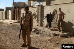 Iraqi soldiers stand guard in Al-Shayma neighborhood that was captured by Iraqi forces from Islamic State militants, southeast of Mosul, Iraq, Nov. 22, 2016. The IS reportedly has used chemical weapons during 19 attacks in areas around Mosul.