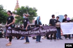 ក្រុម​អ្នក​តវ៉ា​មក​ពី​សហគមន៍​ ដែល​មាន​ជម្លោះ​ដី​ធ្លី​ប្រមាណ​១០០០​នាក់​ នៅ​ក្នុង​រាជធានី​ភ្នំពេញ​ បាន​ហែ​ញតិ្ត​ទៅ​ដាក់​រដ្ឋ​សភាជាតិ​ ក្នុង​ឱកាស​ទិវា​លំនៅដ្ឋាន​ពិភពលោក​ខួប​លើក​ទី​៣០ កាល​ពី​ថ្ងៃ​ទី​៥ ខែ​តុលា ឆ្នាំ​២០១៥។​ (ឡេង ឡែន/VOA)