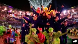 Athletes pose with dancers during the closing ceremony in the Maracana stadium at the 2016 Summer Olympics in Rio de Janeiro, Brazil, Aug. 21, 2016.