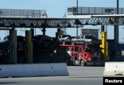 New trucks are transported across the the border into the United States from Mexico at a federal facility in Otay Mesa, California, Jan. 27, 2017.