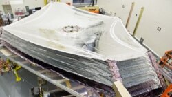 The sun shield of the James Webb Space Telescope separates the observatory into a warm, sun-facing side and a cold side. The five-layer sunshield keeps sunlight from interfering with the sensitive telescope instruments. (Photo Credit: Northrop Grumman)