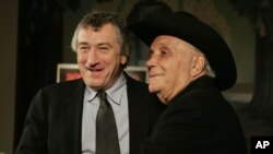 FILE - Jake LaMotta, right, and actor Robert DeNiro stand for photographers before watching a 25th anniversary screening of the movie "Raging Bull" in New York, Jan. 27, 2005.