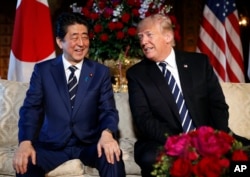 FILE - President Donald Trump and Japanese Prime Minister Shinzo Abe smile during their meeting at Trump's private Mar-a-Lago resort in Palm Beach, Fla., April 17, 2018.
