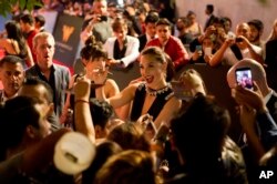 FILE - Actress Gal Gadot signs autographs and greets fans during the Latin American premiere of the film "Wonder Woman," in Mexico City, May 27, 2017.