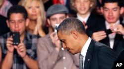 President Barack Obama walks off the stage after speaking about the Aurora, Colorado shooting in Fort Myers, Florida, July 20, 2012.