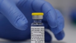 In this Wednesday, Oct. 7, 2020, file photo, a vial of the Phase 3 Novavax coronavirus vaccine is seen ready for use in the trial at St. George's University hospital in London. (AP Photo/Alastair Grant, File)