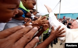 Pope Francis greets people in a neighborhood in Cartagena, Colombia, Sept. 10, 2017.