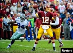 Dec 22, 2013; Landover, MD, USA; Washington Redskins quarterback Kirk Cousins (12) throws the ball as Dallas Cowboys defensive end DeMarcus Ware (94) rushes during the first half at FedEx Field. Mandatory Credit: Brad Mills-USA TODAY Sports - RTX16RRW