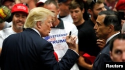 FILE - Republican U.S. presidential candidate Donald Trump, left, speaks with U.S. Representative Darrell Issa, right, after a rally with supporters in San Diego, California, May 27, 2016.