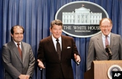 FILE - In this June 17, 1986 file photo, President Ronald Reagan announces the nomination of Antonin Scalia, left, to the Supreme Court. William Rehnquist is at right.