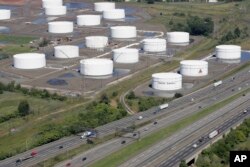FILE - Traffic on I-95 passes Citgo oil storage tanks in Linden, N.J., Sept. 8, 2008.