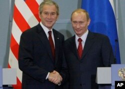 FILE - US President George W. Bush, left, with Russian President Vladimir Putin, right, at the end of their joint and final news conference, Sunday, April 6, 2008 in Sochi, Russia. (AP Photo/Pablo Martinez Monsivais)