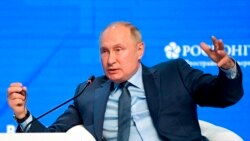 FILE - Russian President Vladimir Putin gestures while speaking at the plenary session of the Russian Energy Week in Moscow, Russia, Oct. 13, 2021.