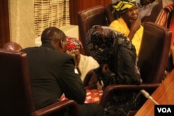 FILE - Rescued "Chibok girl" Amina Ali is shown seated and wearing a veil before a news conference at the presidential villa in Abuja, Nigeria, May 19, 2016. (C. Stein/VOA)