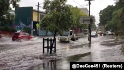 Vehicles drive on a flooded street in Sydney, New South Wales, Australia, Nov. 28, 2018 in this still image taken from a video obtained from social media.