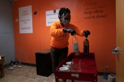 Yashica Budde, a therapist and owner of Smash RX LLC, sets up a rage room with wine bottles for people to break in Westlake Village, California, Feb. 5, 2021. (AP Photo/Jae C. Hong)