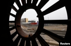 Pembangkit listrik tenaga nuklir Heysham terlihat melalui potongan besi tua di Pelabuhan Heysham di barat laut Inggris.