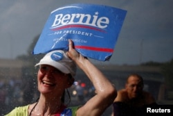 A supporter of U.S. Senator Bernie Sanders walks past a water hydrant during a protest march ahead of the 2016 Democratic National Convention in Philadelphia, Pennsylvania, July 24, 2016.