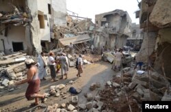 People gather at the site of a Saudi-led air strike in the Red Sea port city of Hodeidah, Yemen, Sept. 22, 2016.