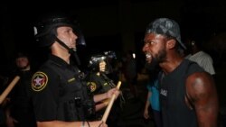 A man confronts police outside the Kenosha Police Department in Kenosha, Wisconsin, U.S., during protests following the police shooting of Black man Jacob Blake August 23, 2020.
