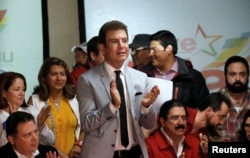 Salvador Nasralla, presidential candidate of the Opposition Alliance Against the Dictatorship applauds next to Former Honduran President Manuel Zelaya as they attend a news conference in Tegucigalpa, Honduras, Dec. 4, 2017.