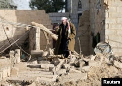 A man walks at the site of a Saudi-led air strike in the Houthi-held capital Sanaa, Yemen, Jan. 20, 2019.