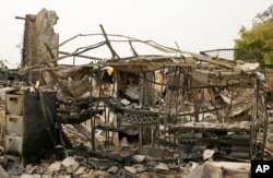 The remains of burned bottles of wine are seen on a rack at the Signorello Estate winery, Oct. 10, 2017, in Napa, California.