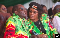 FILE - Zimbabwean President Robert Mugabe and his wife Grace follow proceedings during a youth rally in Marondera about 100 kilometers east of Harare, June, 2, 2017.