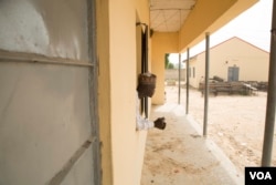Baba Goni Ibrahim, a science teacher at an all-girls high school in Maiduguri, Nigeria, looks out of a classroom window at the campus, Oct. 5, 2016. (C. Oduah/VOA)