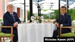 US President Donald Trump (L) sits to lunch with French President Emmanuel Macron at the Hotel du Palais in Biarritz, south-west France on August 24, 2019, on the first day of the annual G7 Summit attended by the leaders of the world's seven richest democ