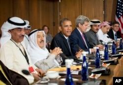 President Barack Obama sits with Kuwaiti Emir Sheikh Sabah Al-Ahmad Al-Sabah, left center, Secretary of State John Kerry, right center, and other Gulf Cooperation Council leaders and delegations at Camp David, Md., May 14, 2015.