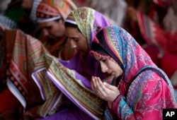 FILE - Pakistani women offer Friday prayers at historical Badshahi mosque during the holy fasting month of Ramadan, in Lahore, Pakistan, June 24, 2016.