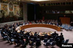 FILE - The United Nations Security Council votes on resolution on humanitarian aid for Syria at U.N. headquarters in New York, Feb. 22, 2014.