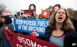 FILE - Kristin Cook, right, of Potomac, Md., joins a rally outside the White House in Washington.