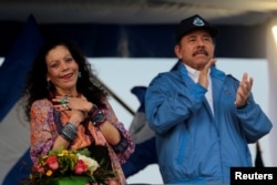 FILE - Nicaraguan President Daniel Ortega and Vice President Rosario Murillo greet supporters in Managua, Nicaragua, Oct. 13, 2018.
