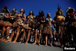Indigenous people attend a protest to defend indigenous land and cultural rights that they say are threatened by the right-wing government of Brazil's President Jair Bolsonaro, in Brasilia, April 26, 2019.