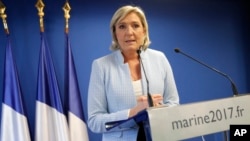 FILE - French far-right leader Marine le Pen makes a statement in Nanterre, outside Paris, Nov. 9, 2016.