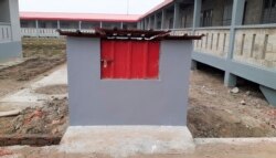 FILE- In this Thursday, Dec. 19, 2019 file photo, a newly constructed garbage bin stands by residential houses on Bhasan Char, or floating island, in the Bay of Bengal, Bangladesh.