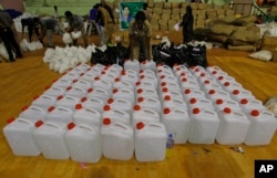 A policewoman sorts drinking water to be distributed to flood victims at the Jawarhalal Nehru Indoor stadium in Chennai, India, Dec. 6, 2015.