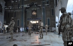 Pakistani para-military soldiers guard the site of a deadly suicide attack at the shrine of famous Sufi Lal Shahbaz Qalandar in Sehwan, Pakistan, Feb. 16, 2017. Pakistan military’s says that the attack was among incidents that prompted a an intensified anti-terror crackdown by the army.