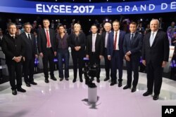 Candidates in France's presidential race pose for a group photo prior to a television debate at French private TV channels BFM TV and CNews, in La Plaine-Saint-Denis, outside Paris, April 4, 2017.