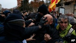 Catalan officers struggle with demonstrators around Lleida museum in the west of Catalonia.