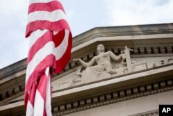 FILE - The front facade of the Robert F. Kennedy Department of Justice Building is seen in Washington, in a June 19, 2015, photo.