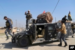 Iraqi Federal police deploy after regaining control of the town of Abu Saif, west of Mosul, Iraq, Feb. 22, 2017.