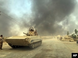 Iraqi Security Forces enter Qayara, 70 kilometers (45 miles) south of Mosul, after defeating Islamic State group forces in northern Iraq, Aug. 25, 2016.
