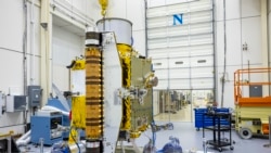 Members of the DART team carefully inspect the spacecraft before performing vibration tests in July 2021. (Image Credit: NASA/Johns Hopkins APL/Ed Whitman)