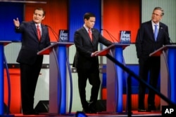 From left, Republican presidential candidate Sen. Ted Cruz answers a question as Sen. Marco Rubio and former Florida Gov. Jeb Bush listen during a primary debate in Des Moines, Iowa, Jan. 28, 2016.