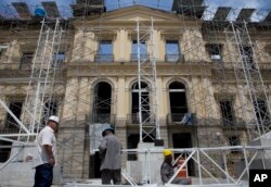 Workers erect scaffolding in front of Brazil's National Museum, in Rio de Janeiro, Brazil, Feb. 12, 2019.